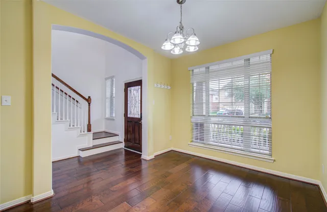 a view of an room with wooden floor and windows