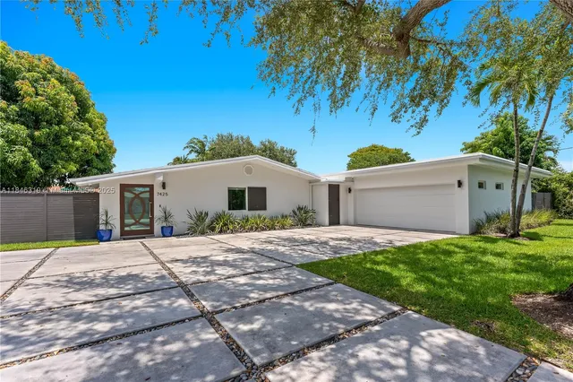 a front view of a house with a yard and a garage