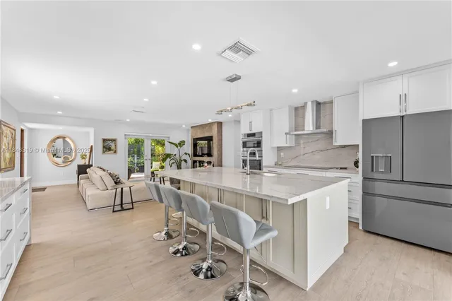 a kitchen with stainless steel appliances granite countertop a sink and stove