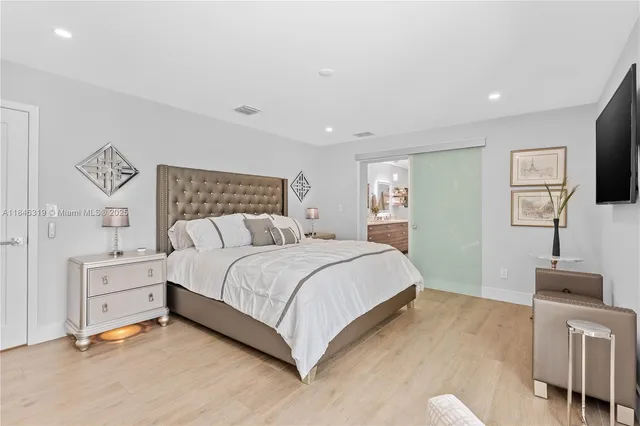 a spacious bathroom with a double vanity sink a mirror and a shower