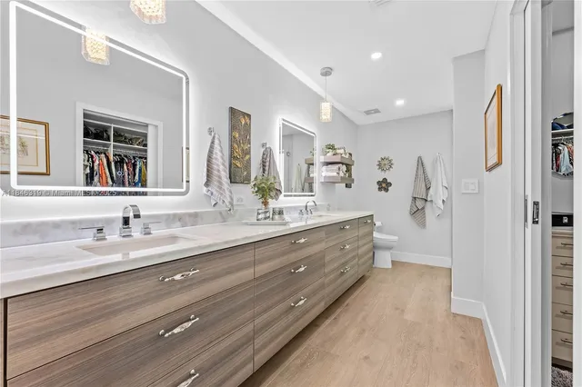 a bedroom with bed and paintings on the wall