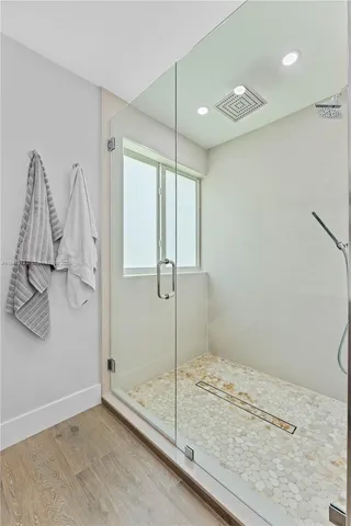 a bathroom with a granite countertop sink a toilet and shower