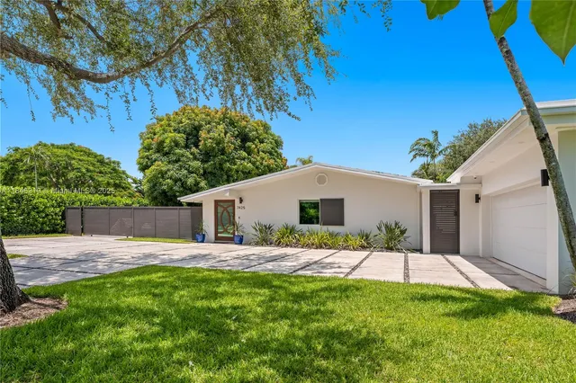 a house view with a sitting space and garden