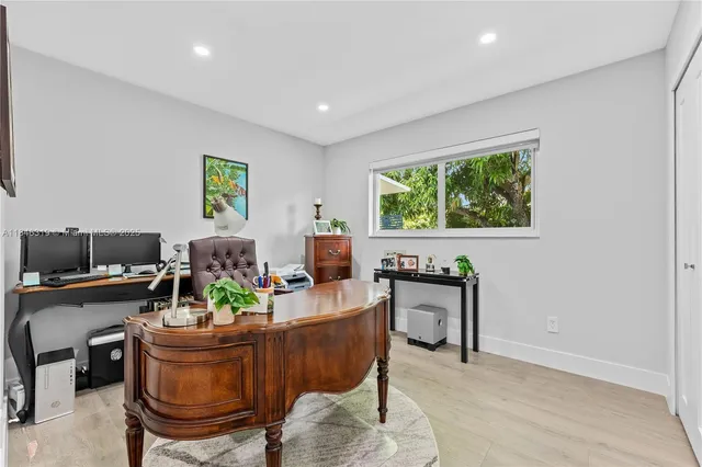 a living room with furniture a table and a large window