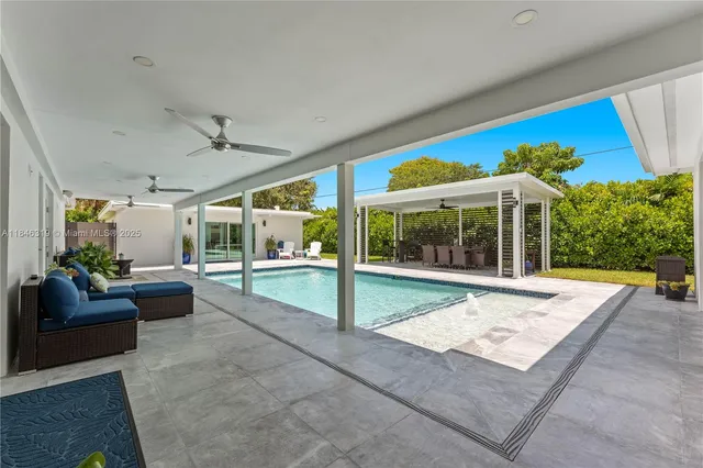 a view of a house with a backyard and sitting area
