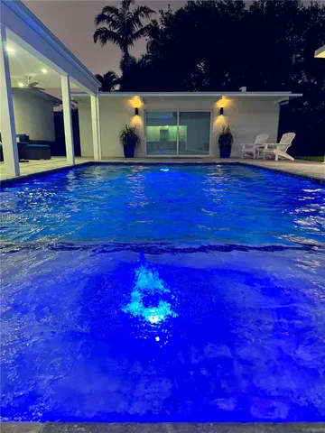 a backyard of a house with table and chairs