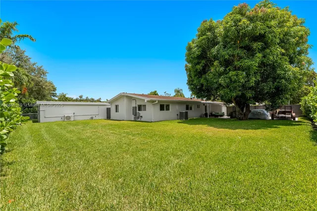a kitchen with appliances a sink and cabinets