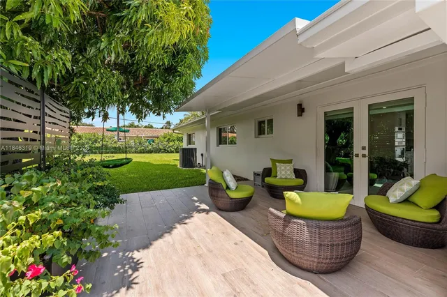 a kitchen with stainless steel appliances a stove a sink a microwave and white cabinets