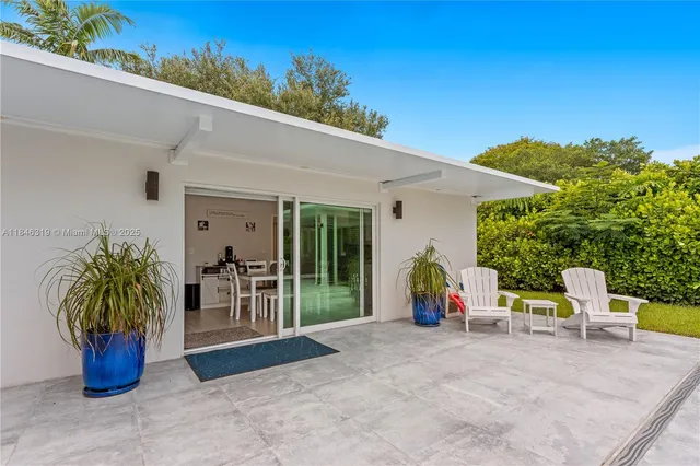 a bedroom with a large bed and a flat screen tv