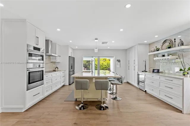 a view of kitchen with sink and center island