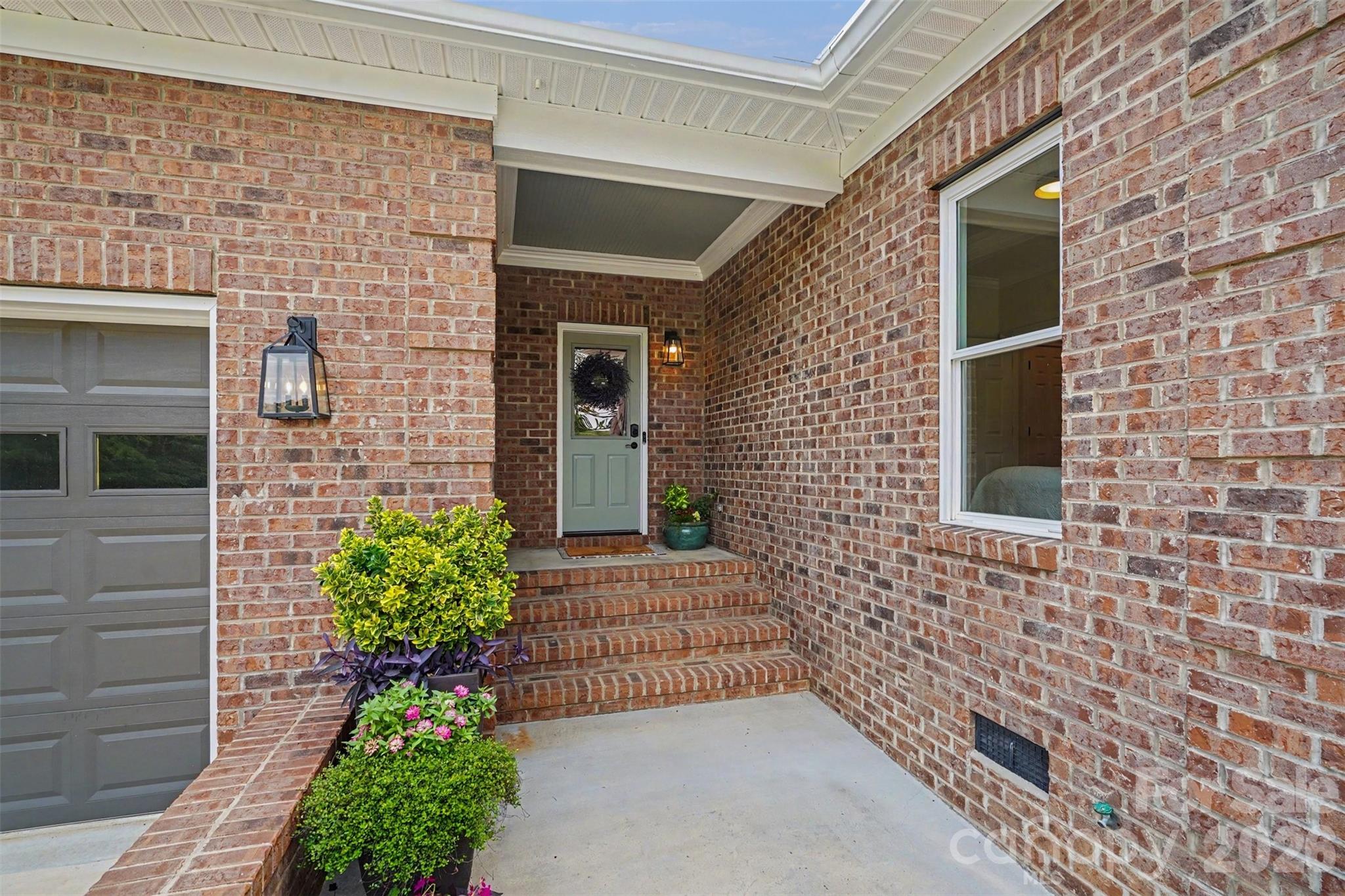 4445 Rowell Road Lancaster, SC 29720 - Photo 26 of 37 a pathway of a house with potted plants