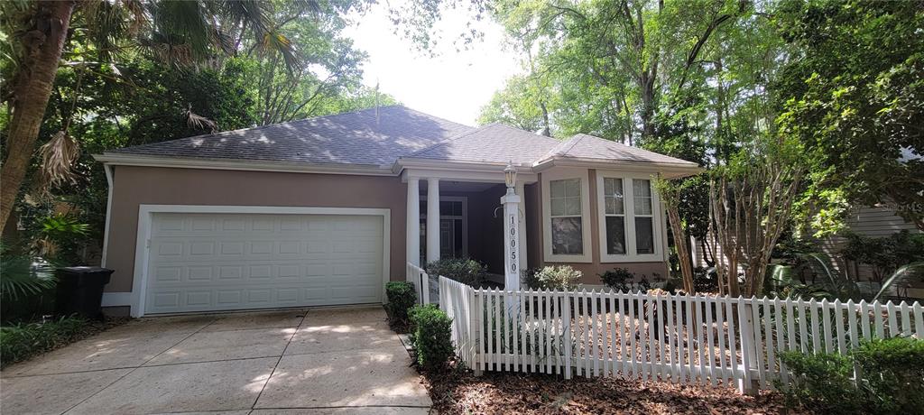 10050 Southwest 52nd Road Gainesville, FL 32608 - Photo 1 of 39 a front view of a house with a garden