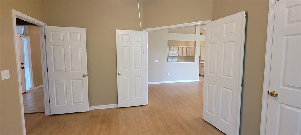 10050 Southwest 52nd Road Gainesville, FL 32608 - Photo 16 of 39 a view of an empty room with wooden floor