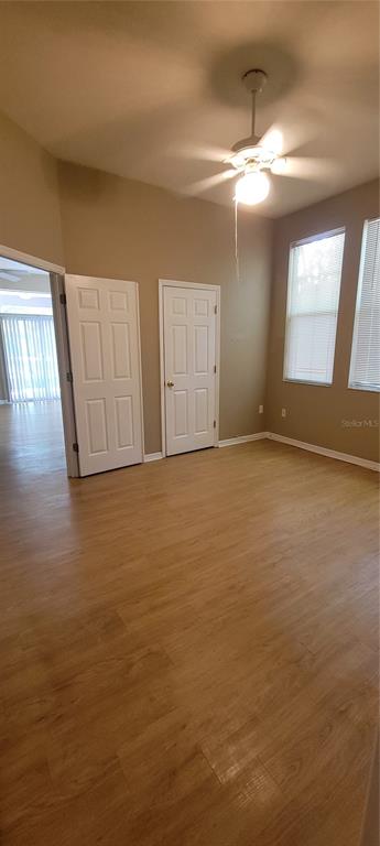 10050 Southwest 52nd Road Gainesville, FL 32608 - Photo 19 of 39 a view of an empty room with window and wooden floor