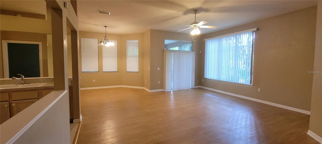 10050 Southwest 52nd Road Gainesville, FL 32608 - Photo 2 of 39 a view of an empty room with window and wooden floor