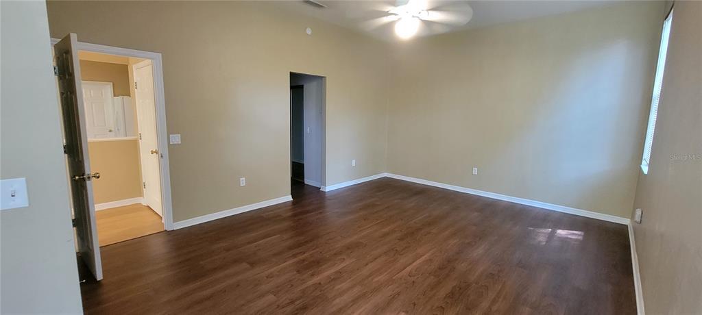 10050 Southwest 52nd Road Gainesville, FL 32608 - Photo 22 of 39 an empty room with wooden floor and windows