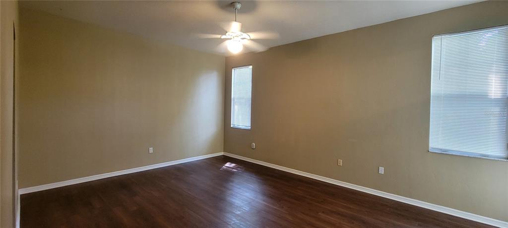 10050 Southwest 52nd Road Gainesville, FL 32608 - Photo 23 of 39 an empty room with wooden floor and windows