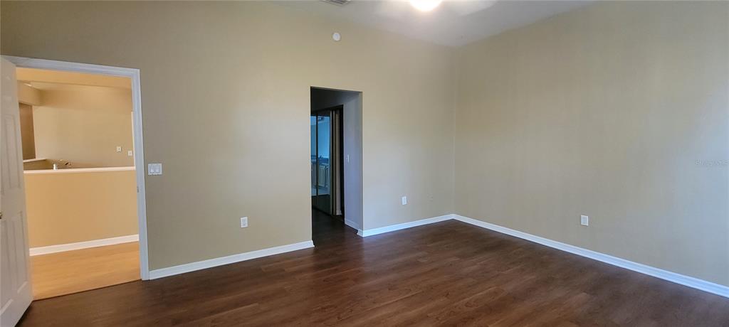 10050 Southwest 52nd Road Gainesville, FL 32608 - Photo 24 of 39 a view of an empty room with wooden floor
