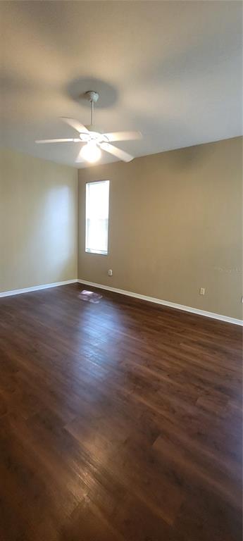 10050 Southwest 52nd Road Gainesville, FL 32608 - Photo 27 of 39 an empty room with wooden floor and windows