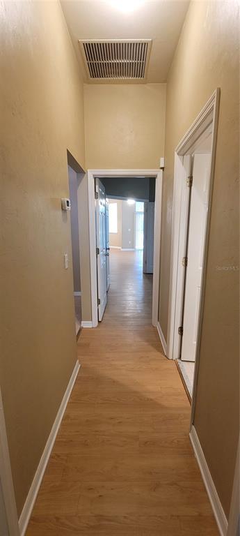 10050 Southwest 52nd Road Gainesville, FL 32608 - Photo 29 of 39 a view of a hallway with wooden floor
