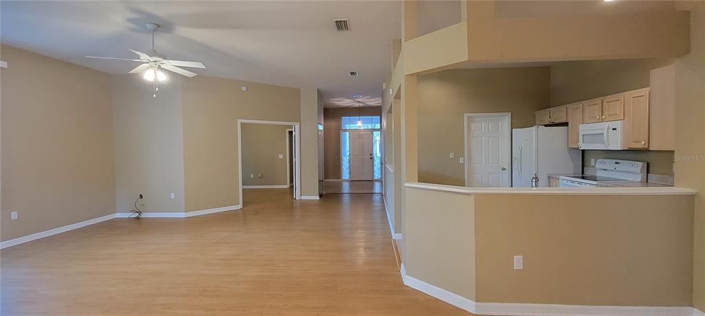 10050 Southwest 52nd Road Gainesville, FL 32608 - Photo 3 of 39 a view of kitchen with cabinets and wooden floor