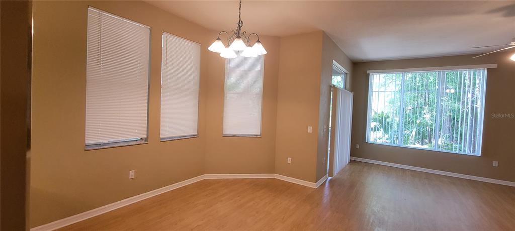 10050 Southwest 52nd Road Gainesville, FL 32608 - Photo 5 of 39 an empty room with windows and chandelier