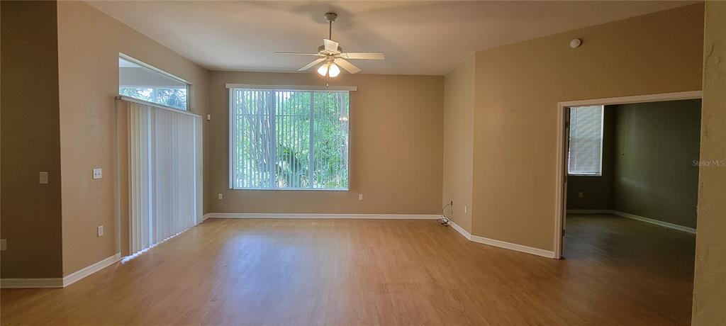 10050 Southwest 52nd Road Gainesville, FL 32608 - Photo 7 of 39 an empty room with wooden floor and windows