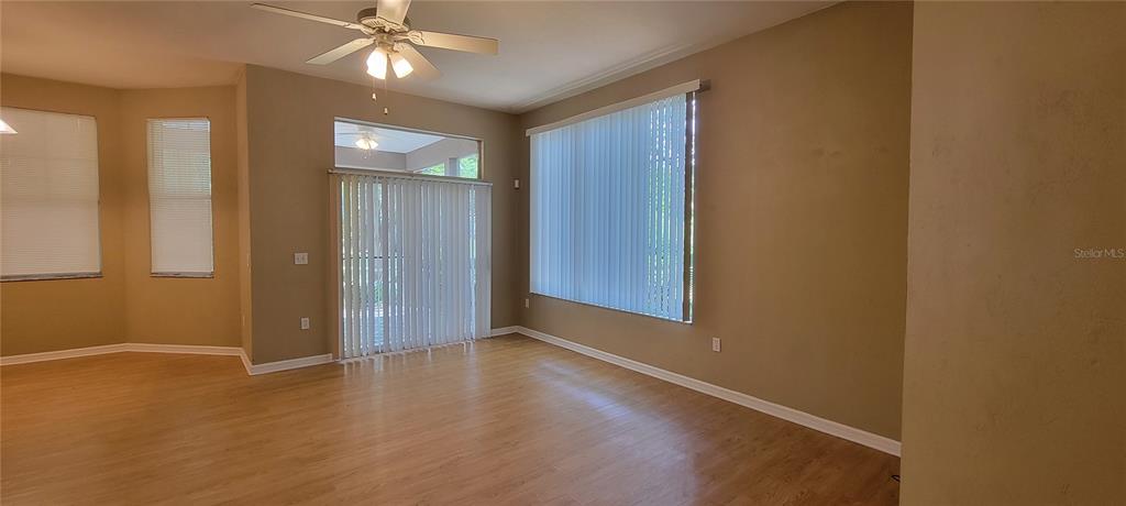 10050 Southwest 52nd Road Gainesville, FL 32608 - Photo 10 of 39 an empty room with wooden floor and door