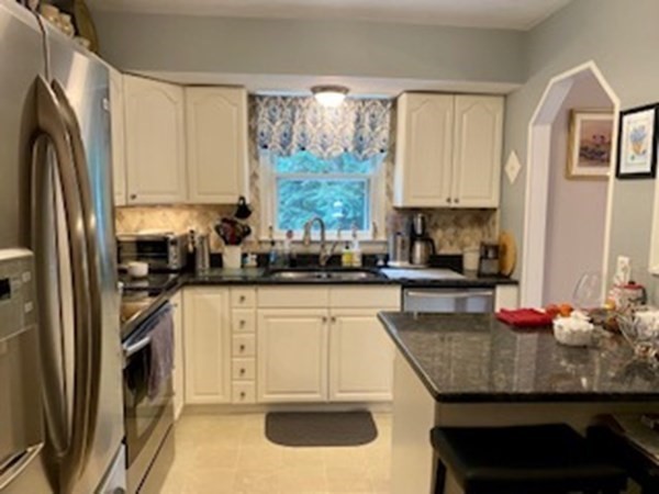 130 Reservoir Road Lunenburg, MA 01462 - Photo 3 of 23 a kitchen with granite countertop a refrigerator sink and stove