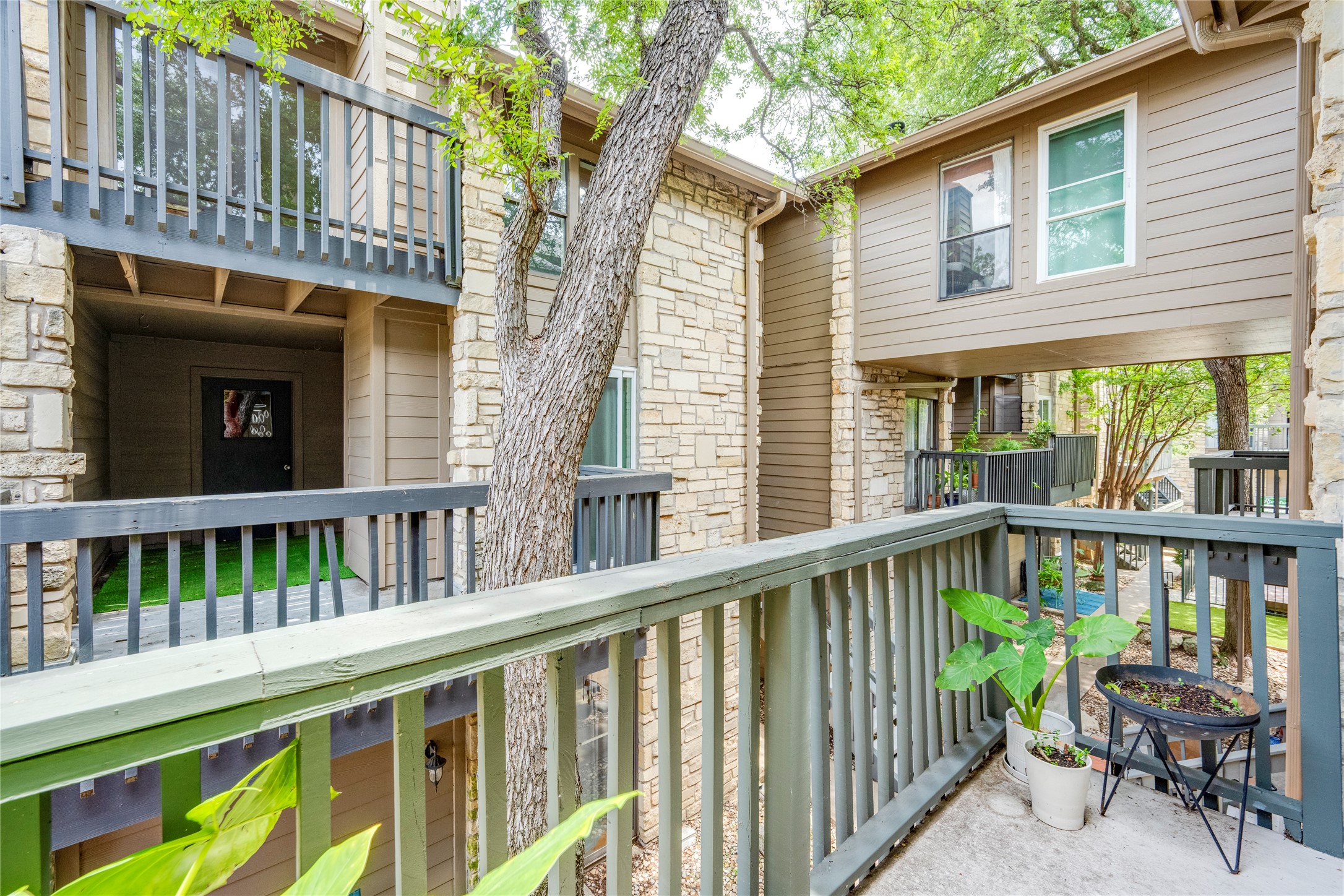 3627 Menchaca Road, Unit 214 Austin, TX 78704 - Photo 19 of 28 A private balcony offers serene views of mature trees and the natural surroundings.