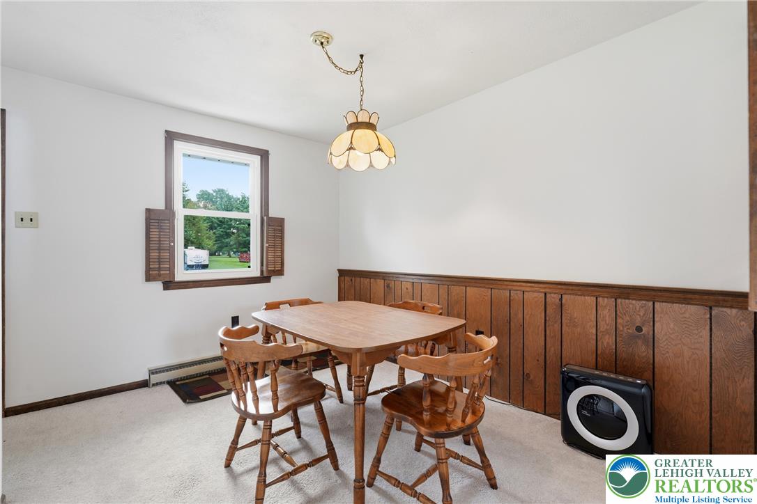 1385 Woodmere Road Pottstown, PA 19464 - Photo 12 of 57 A well-lit dining area offers a cozy space for meals, featuring a window with an outdoor view.