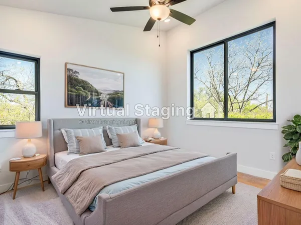 a bedroom with a bed and a painting on the wall
