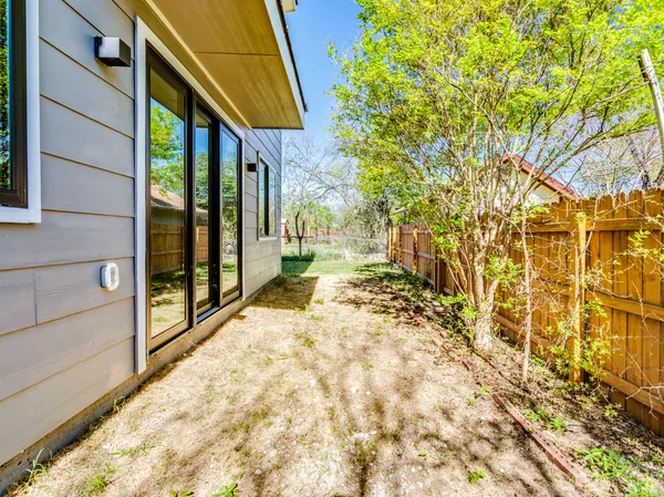 a view of a pathway of a house with a yard