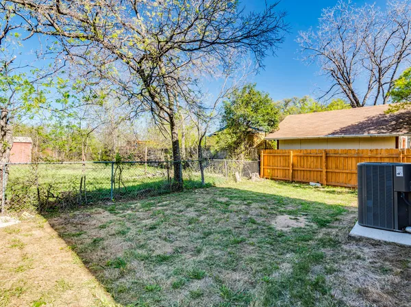 a view of a backyard with large trees