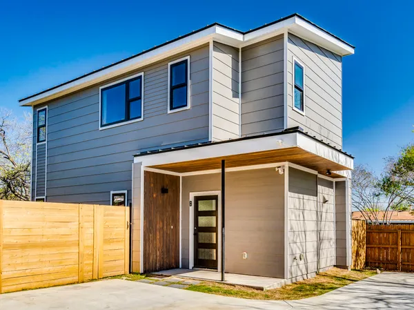 a view of a house with wooden fence