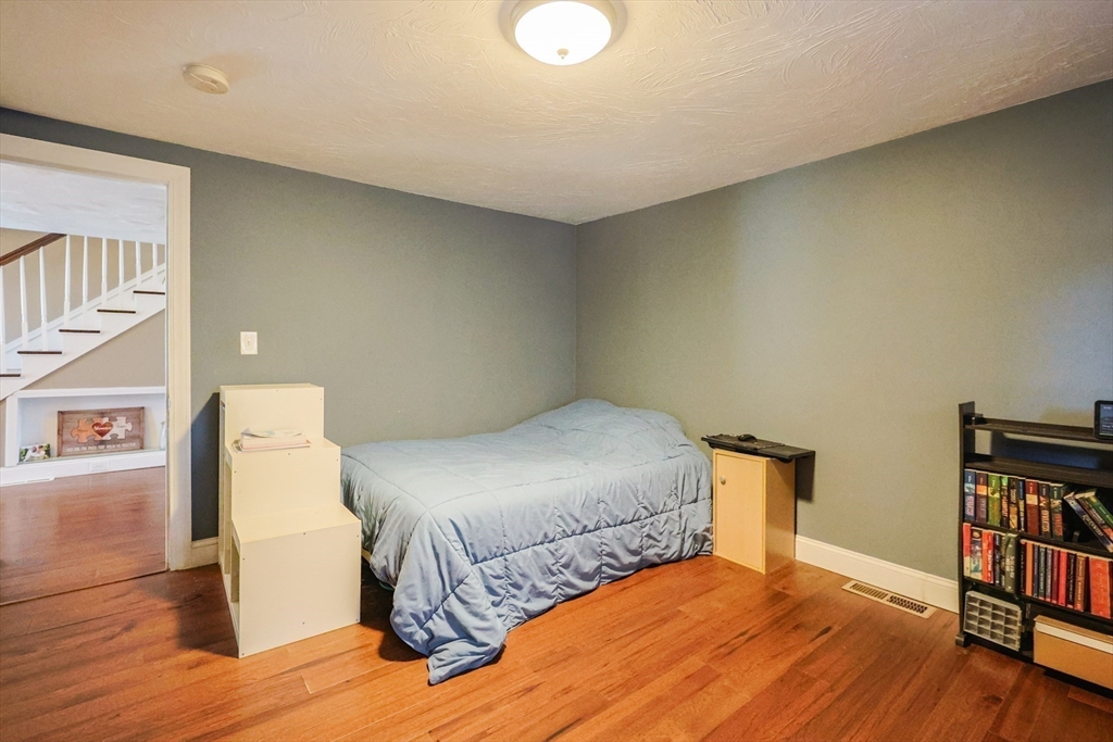 22 Rock Street Acushnet, MA 02743 - Photo 22 of 41 a bedroom with a bed and a book shelf