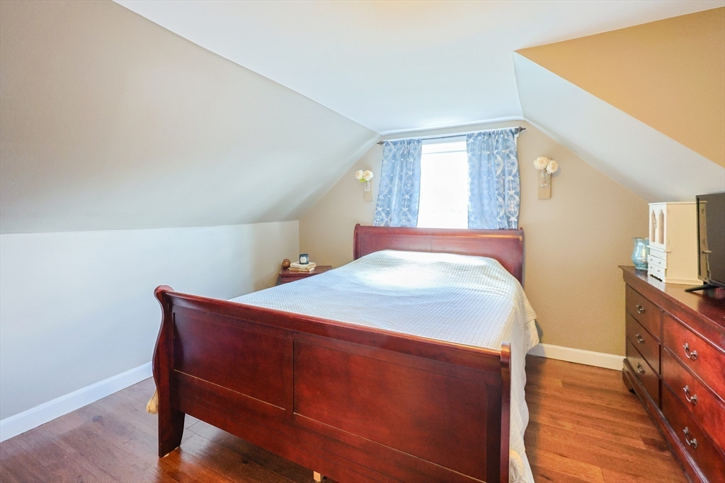 22 Rock Street Acushnet, MA 02743 - Photo 26 of 41 a bedroom with a bed and wooden floor