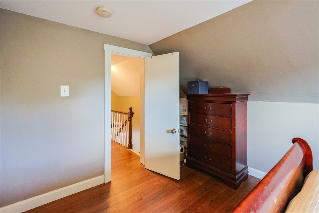 22 Rock Street Acushnet, MA 02743 - Photo 29 of 41 a room with a walk in closet and wooden floor