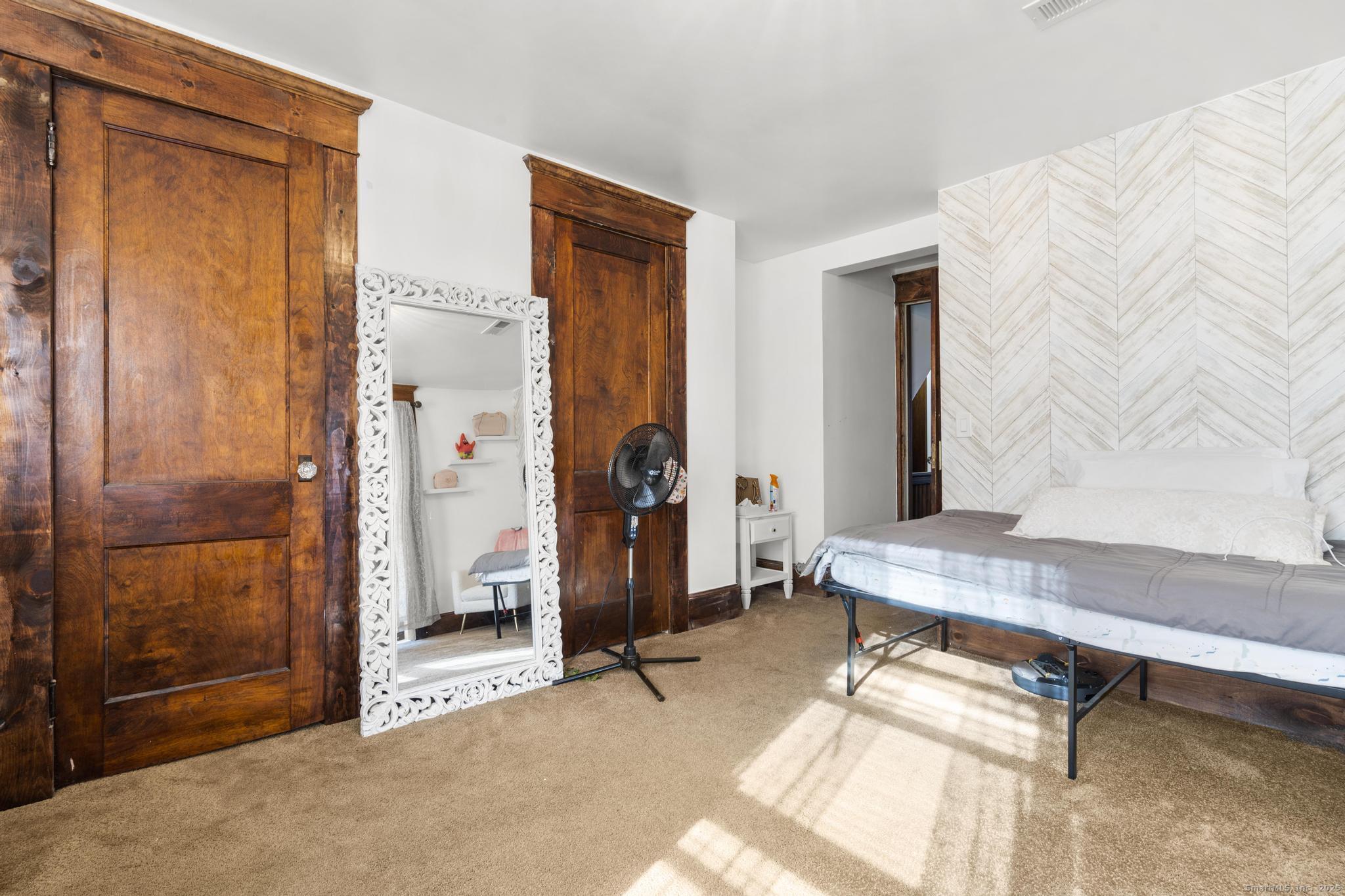 699 Forest Road West Haven, CT 06516 - Photo 12 of 28 a living room with furniture a window and a glass door shower