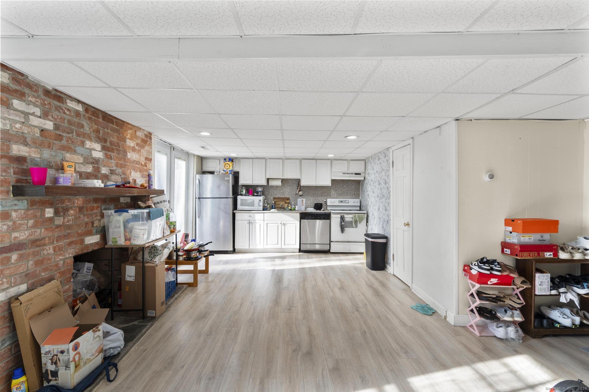 699 Forest Road West Haven, CT 06516 - Photo 15 of 28 a view of a kitchen with furniture and wooden floor