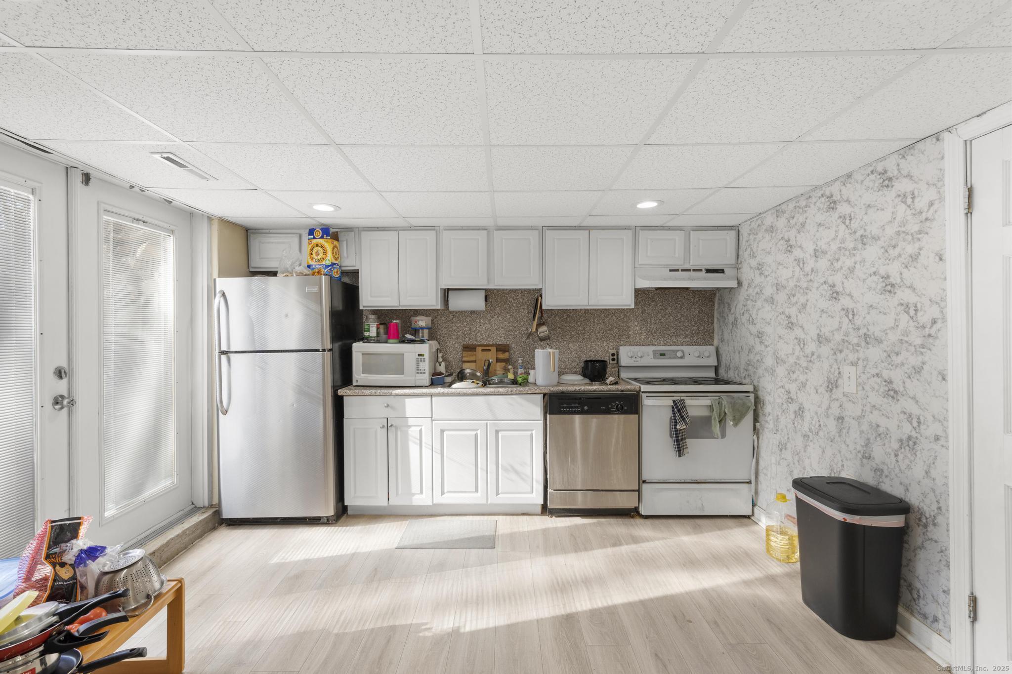 699 Forest Road West Haven, CT 06516 - Photo 16 of 28 a kitchen with stainless steel appliances a refrigerator sink and cabinets