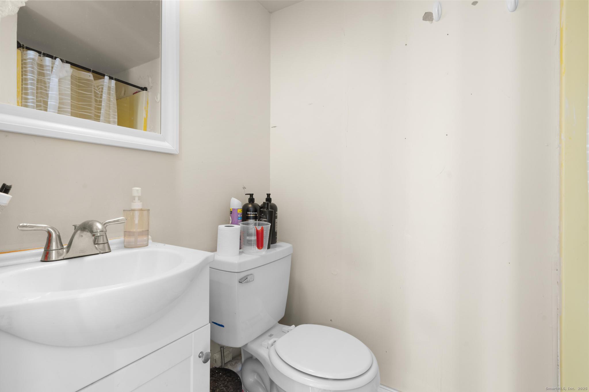 699 Forest Road West Haven, CT 06516 - Photo 17 of 28 a white toilet sitting next to a bathroom sink