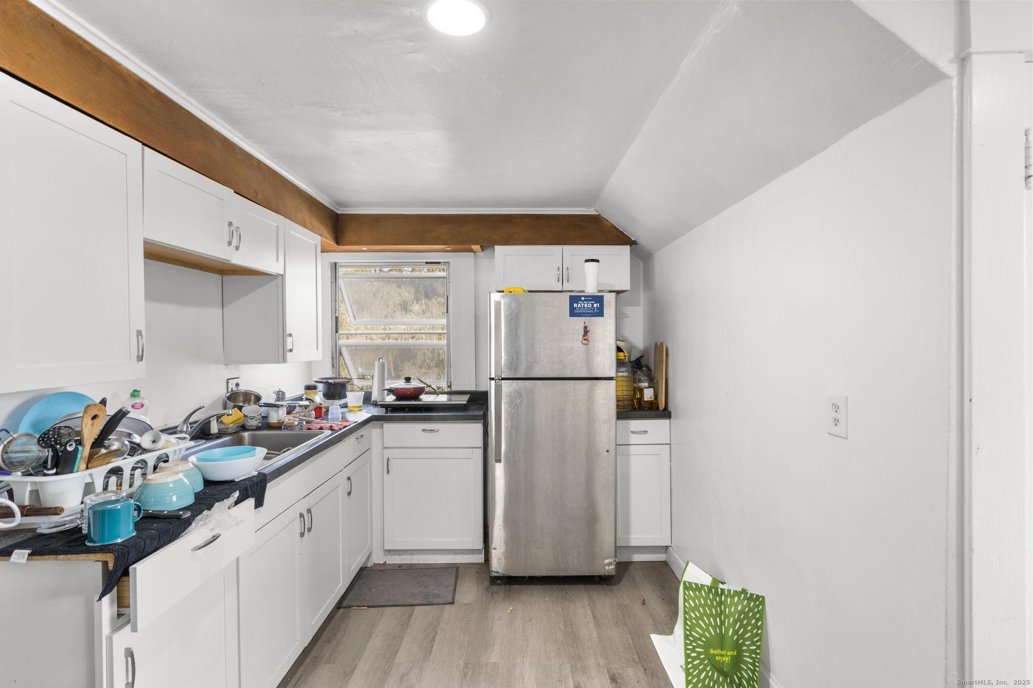699 Forest Road West Haven, CT 06516 - Photo 18 of 28 a kitchen with a sink stove and refrigerator