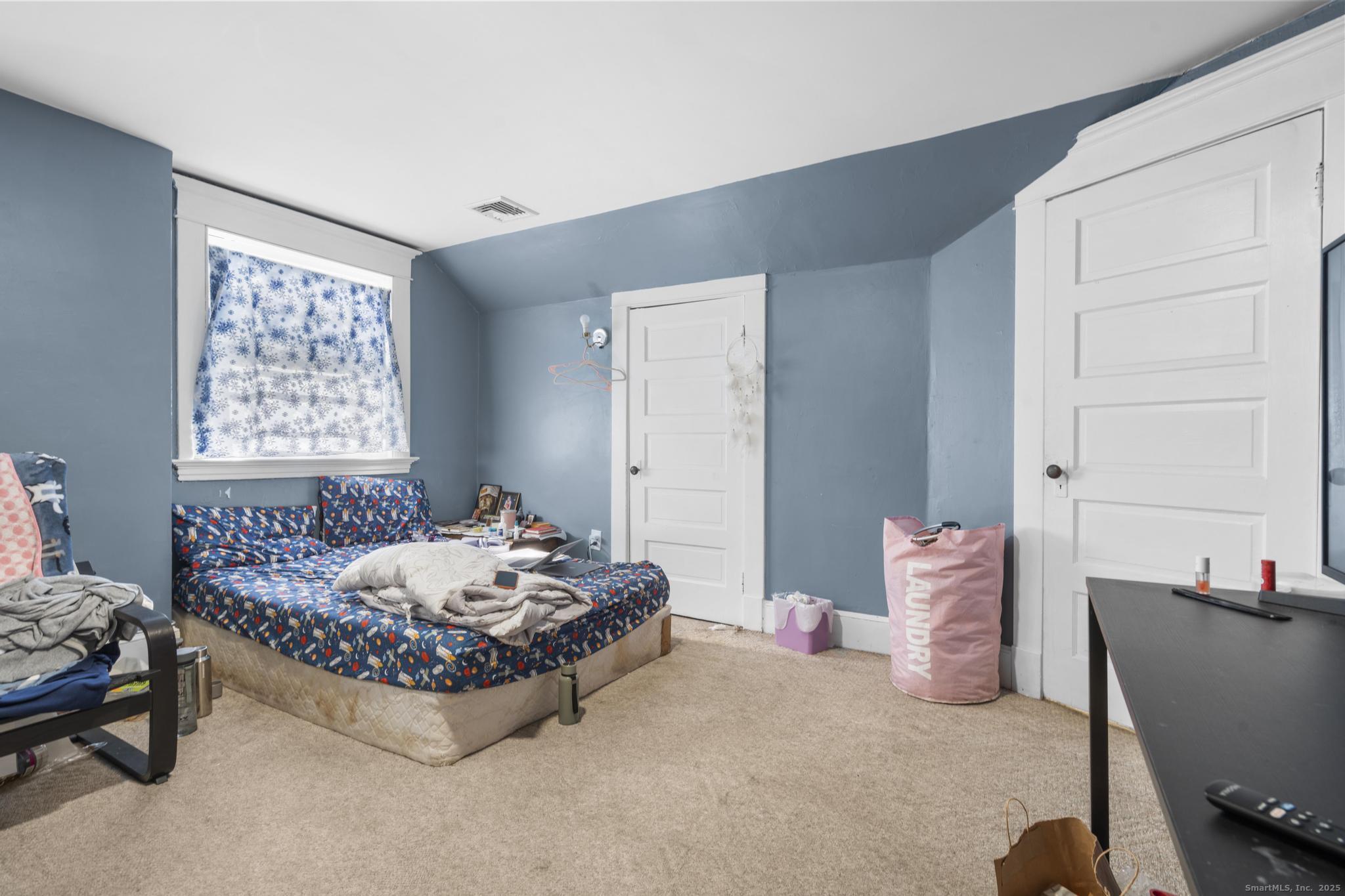 699 Forest Road West Haven, CT 06516 - Photo 22 of 28 a bedroom with a bed and a window