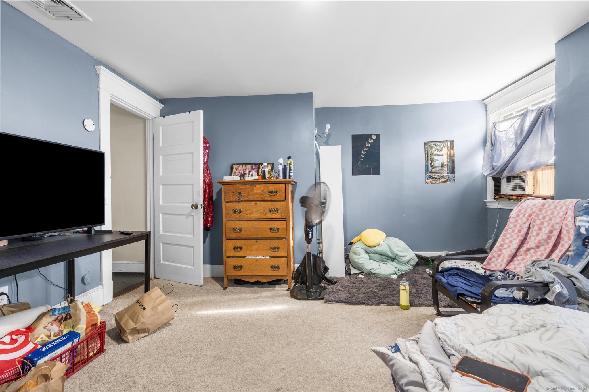 699 Forest Road West Haven, CT 06516 - Photo 23 of 28 a living room with furniture and a flat screen tv