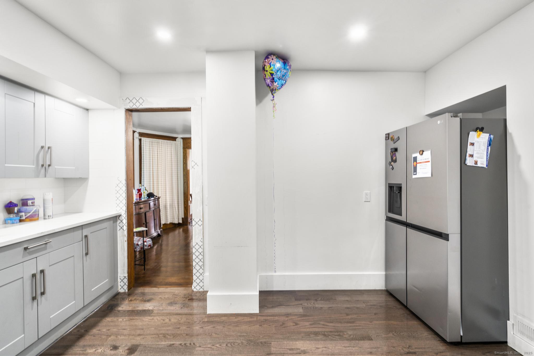 699 Forest Road West Haven, CT 06516 - Photo 7 of 28 a view of a kitchen with refrigerator and wooden floor