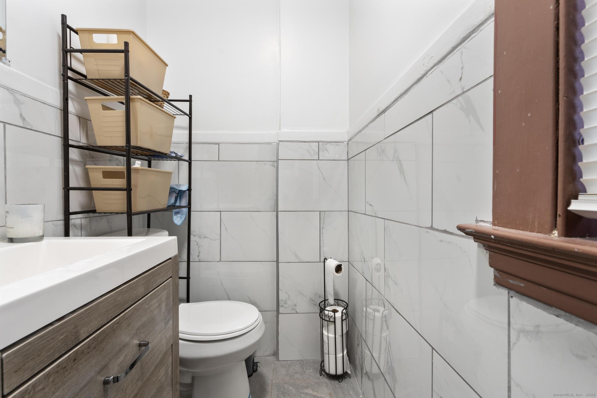 699 Forest Road West Haven, CT 06516 - Photo 8 of 28 a bathroom with a sink toilet and shower