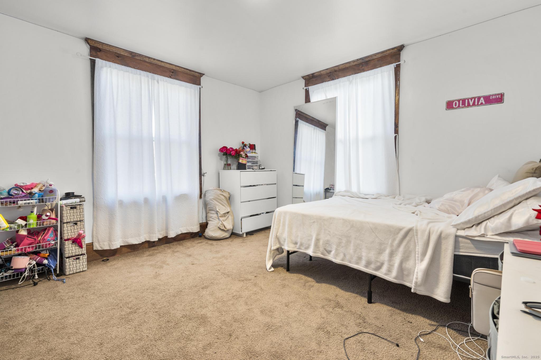 699 Forest Road West Haven, CT 06516 - Photo 9 of 28 a bedroom with a bed and a window