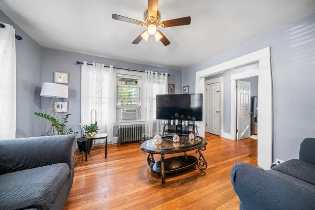 a living room with furniture and a flat screen tv