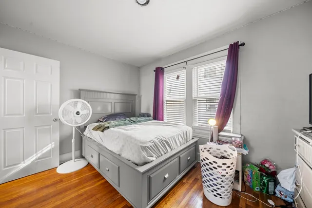 a bed sitting in a bedroom next to a window